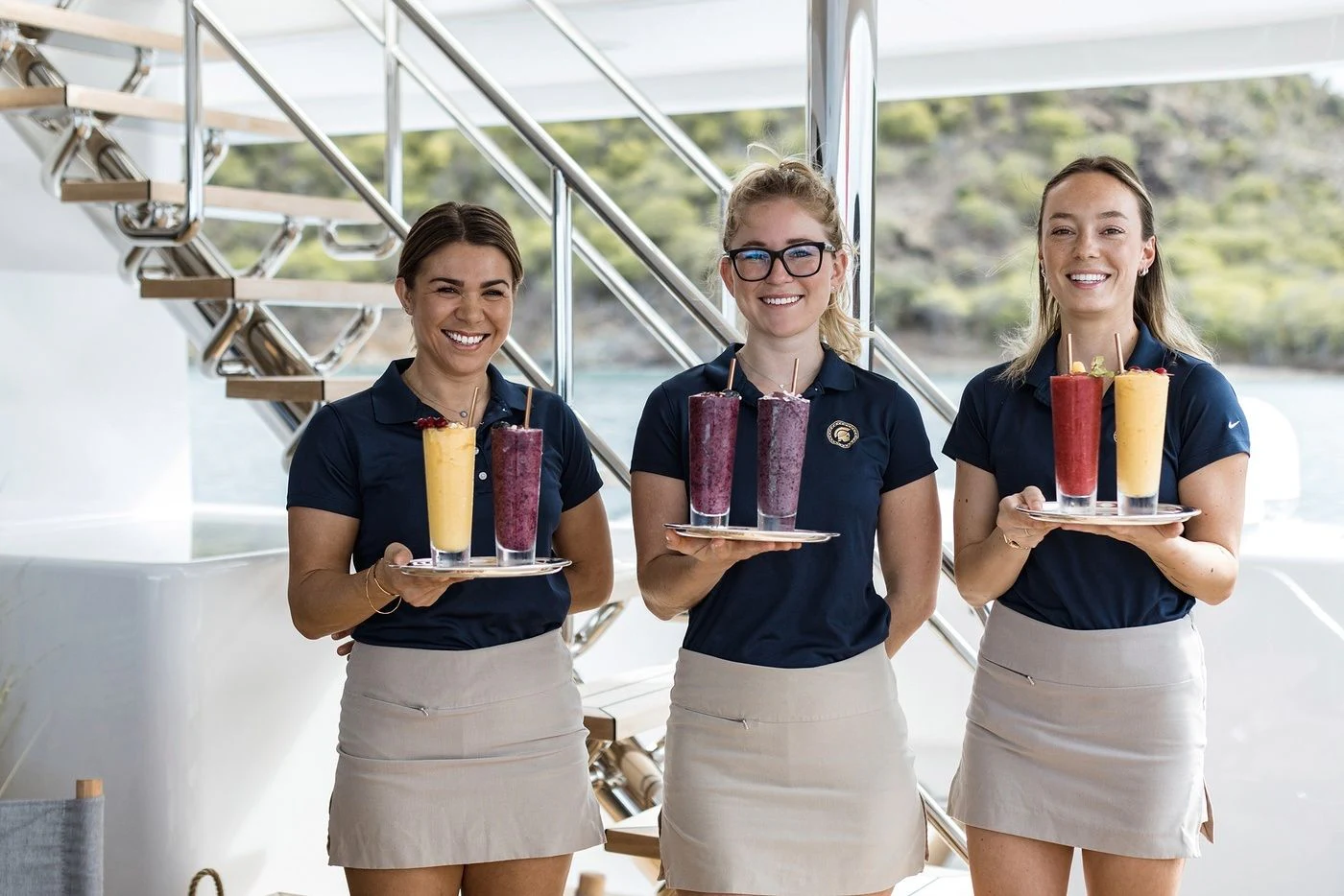 a group of women holding cups of beer aboard GLADIATOR Yacht for Sale