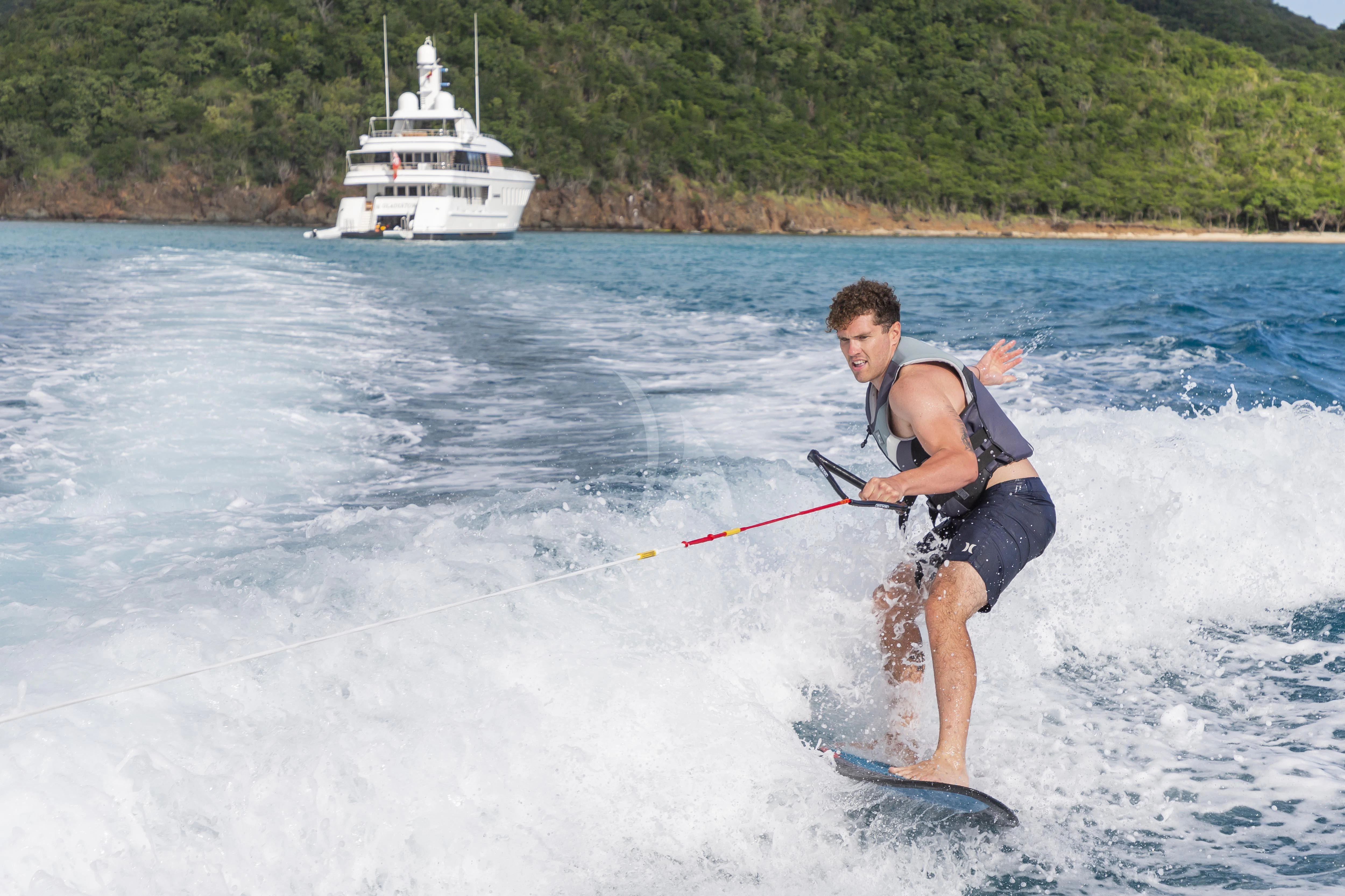 a man water skiing aboard GLADIATOR Yacht for Sale