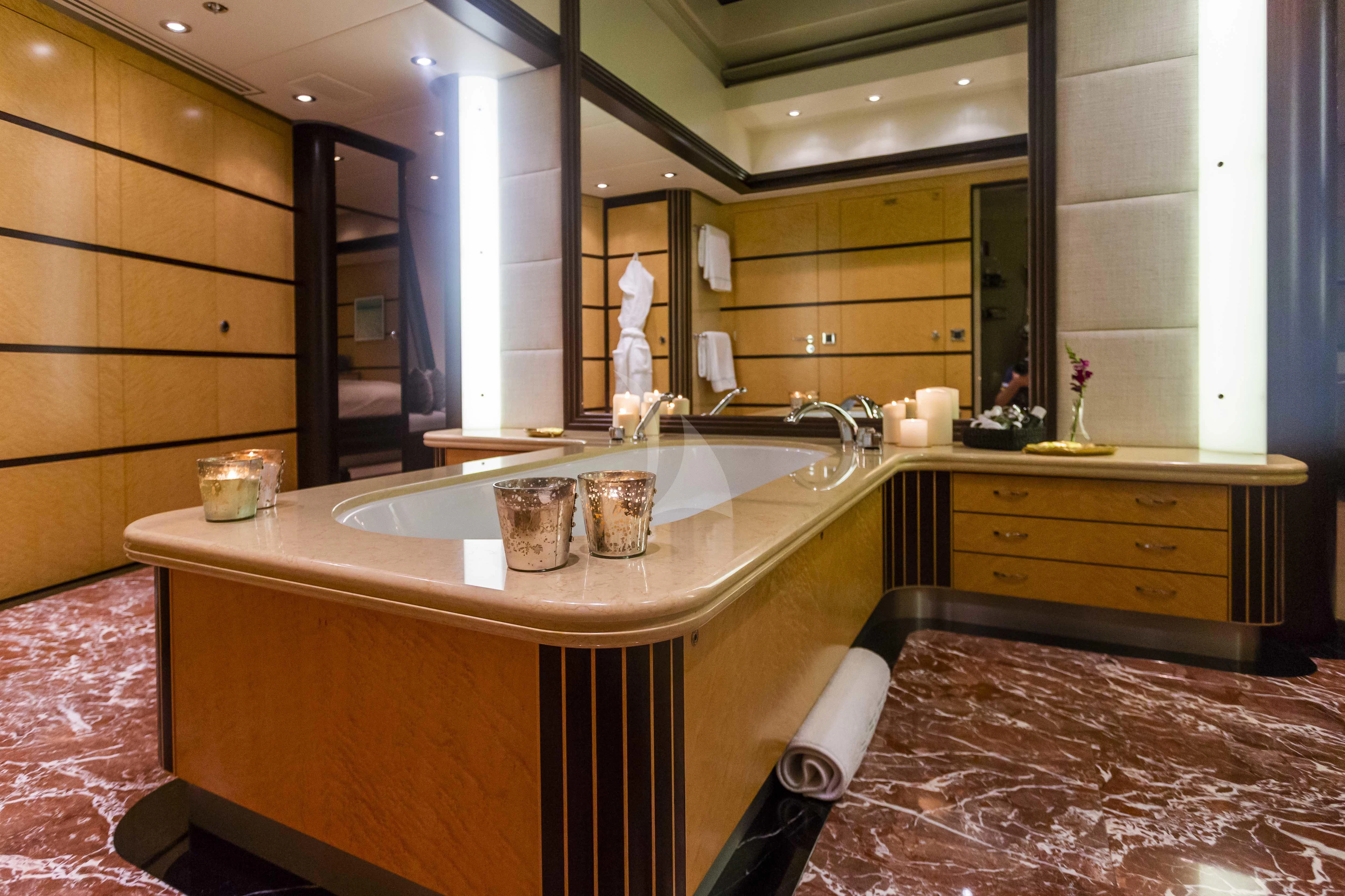 a bathroom with a countertop sink and a mirror aboard GLADIATOR Yacht for Sale