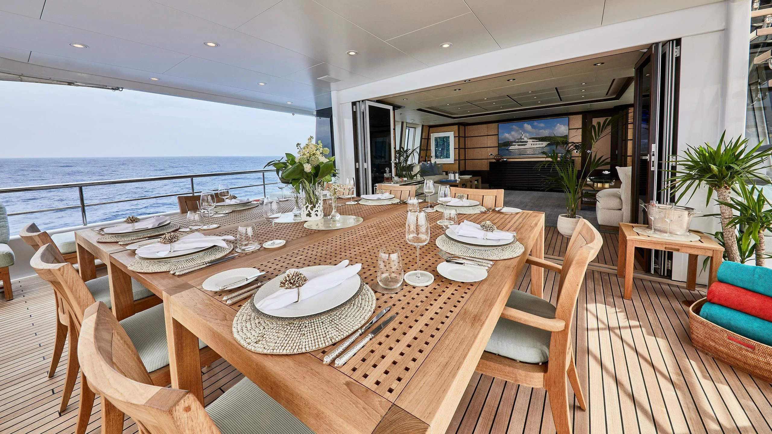 a table set for a meal on a deck overlooking the ocean aboard GLADIATOR Yacht for Sale