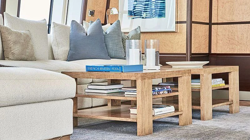 a coffee table with books on it aboard GLADIATOR Yacht for Sale