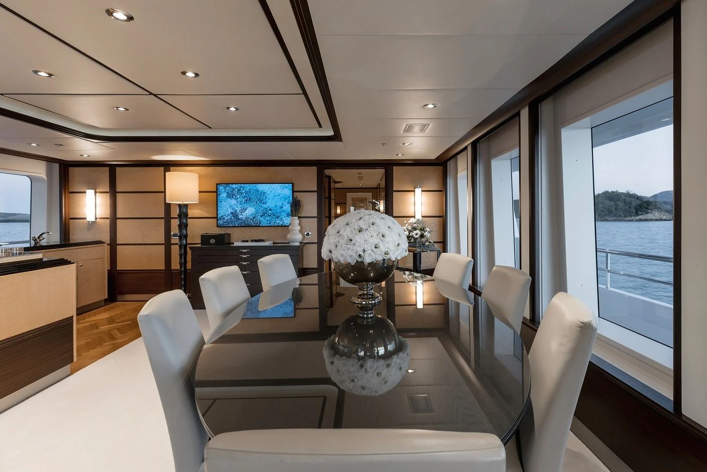 a large room with a large vase of flowers and a television aboard GLADIATOR Yacht for Sale