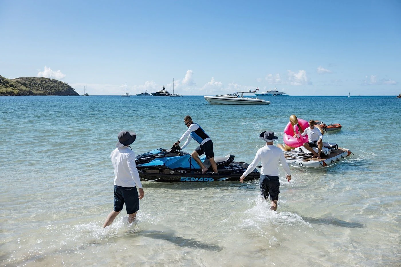 a group of people on a beach aboard GLADIATOR Yacht for Sale