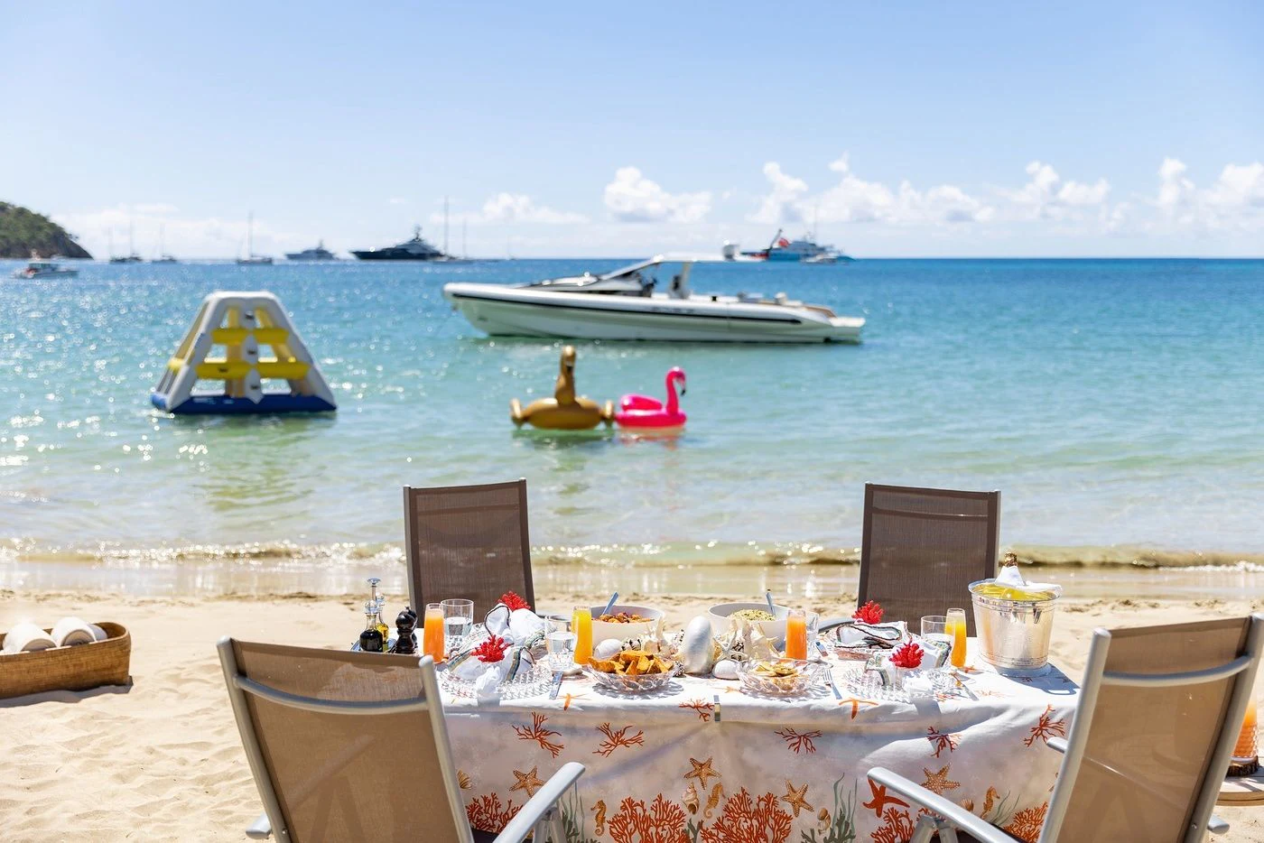 a table with food and drinks on it by the water aboard GLADIATOR Yacht for Sale
