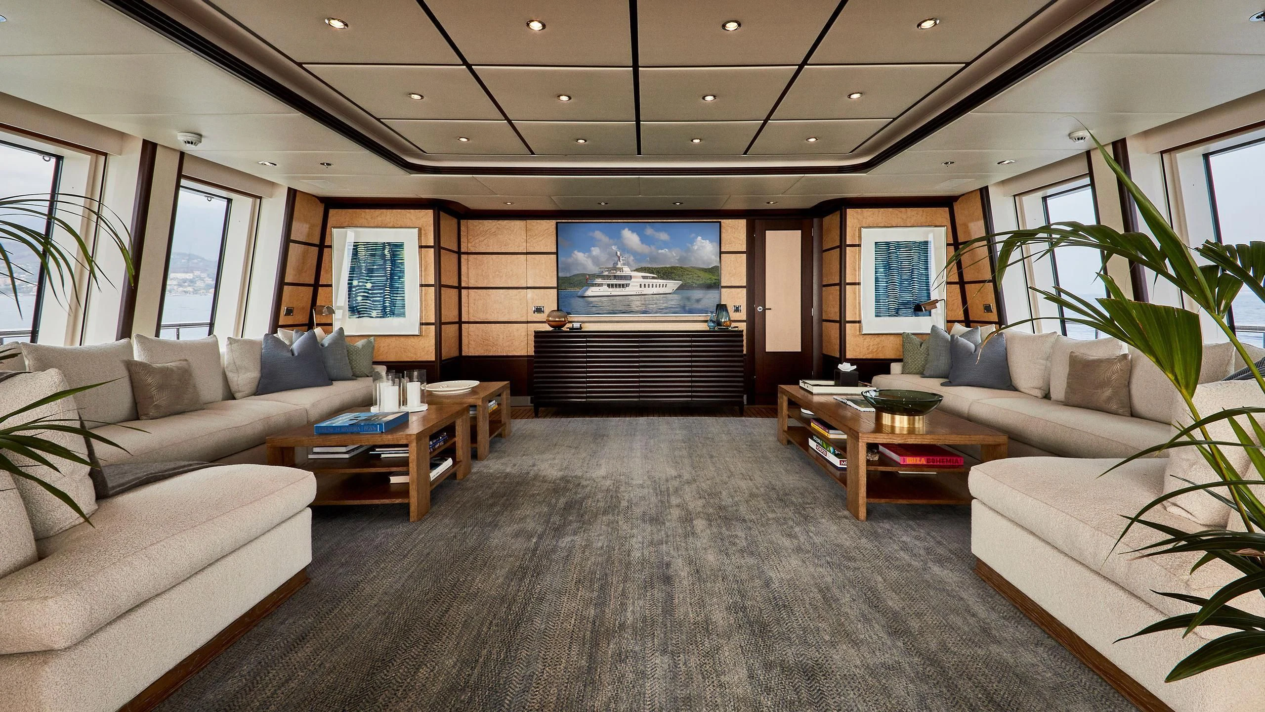 a living room with a couch and a coffee table aboard GLADIATOR Yacht for Sale