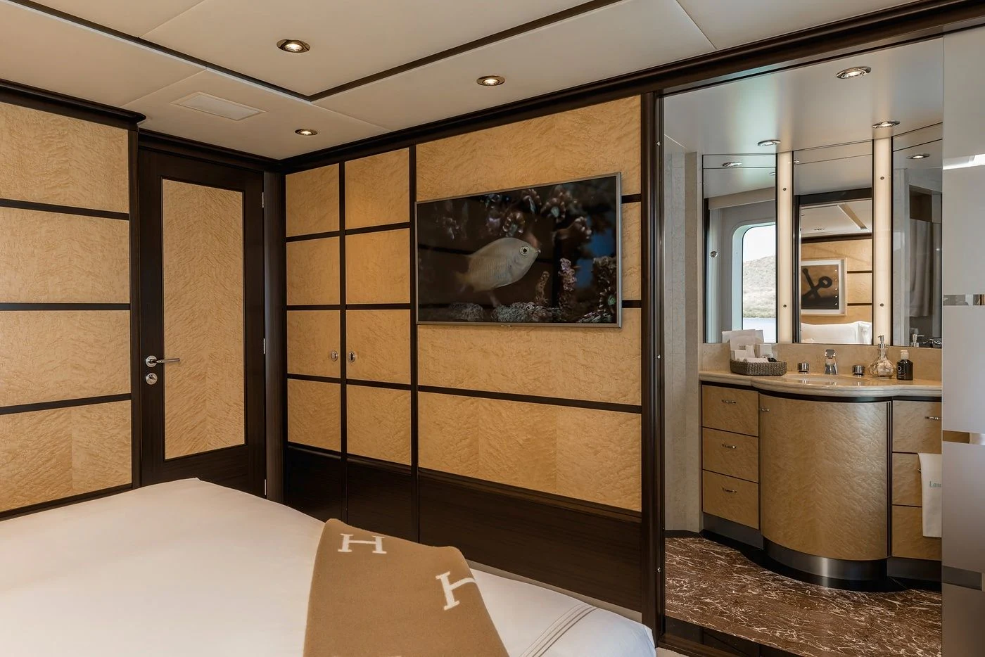 a room with a bed and a mirror aboard GLADIATOR Yacht for Sale