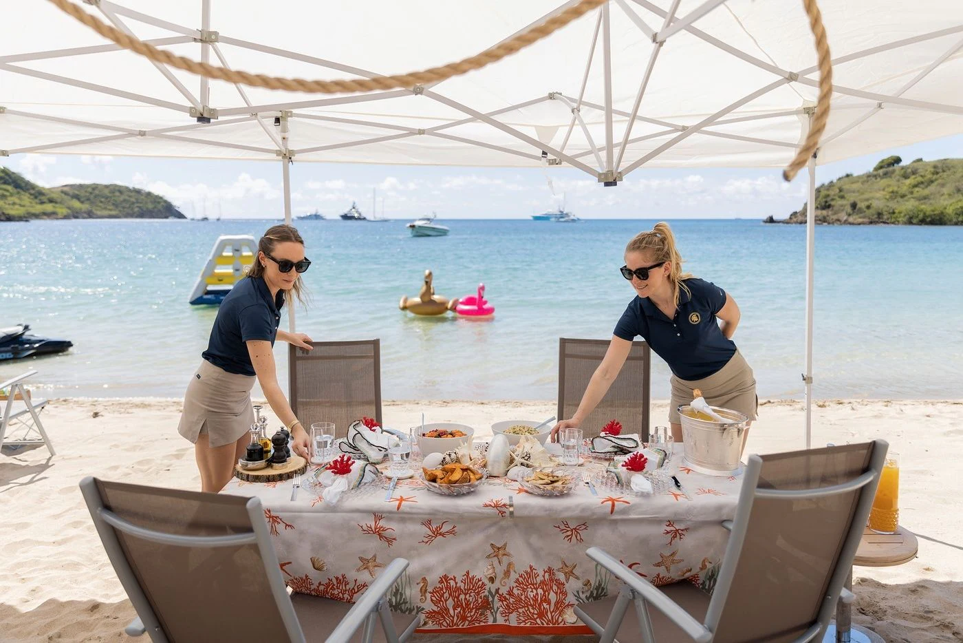 a couple of people at a table with food on it by the water aboard GLADIATOR Yacht for Sale
