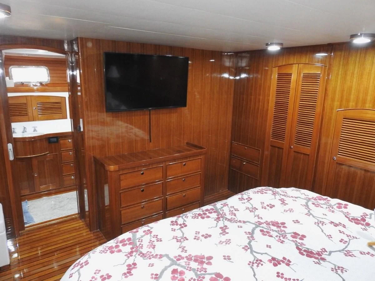 a bedroom with a bed and a television aboard TELEMETRY Yacht for Sale