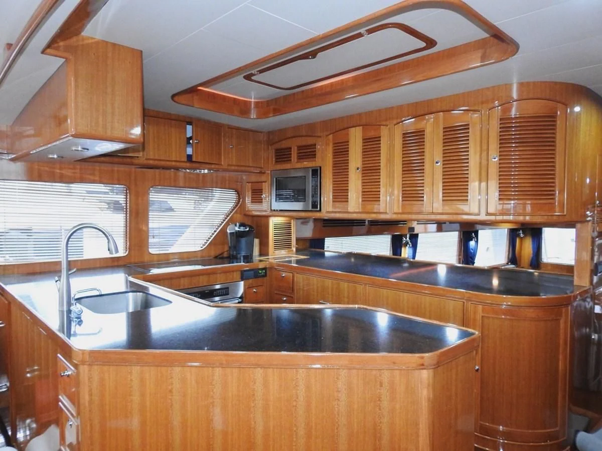 a kitchen with wooden cabinets aboard TELEMETRY Yacht for Sale