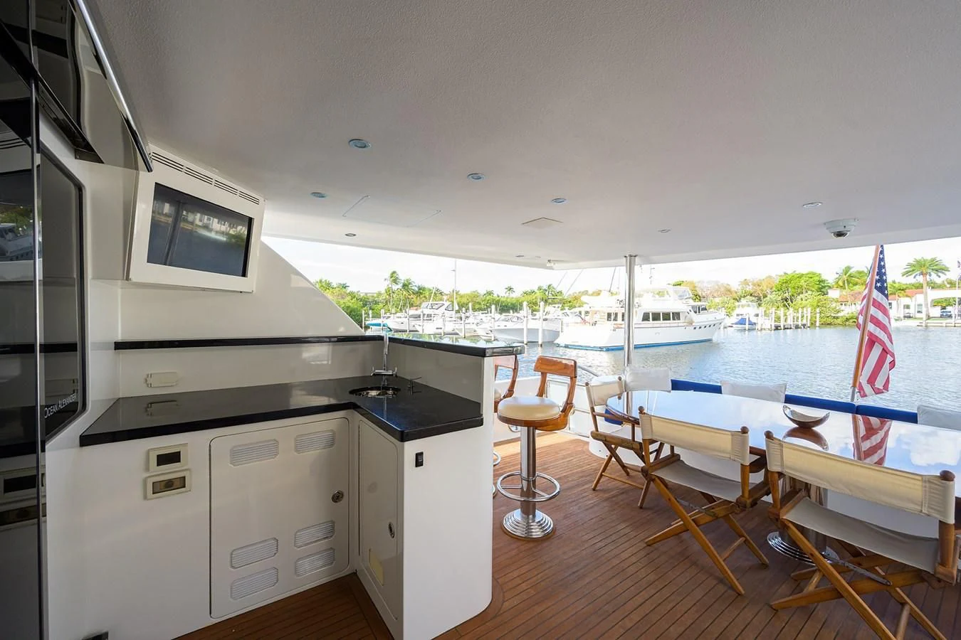 a kitchen with a deck and chairs aboard BARNSTAR Yacht for Sale