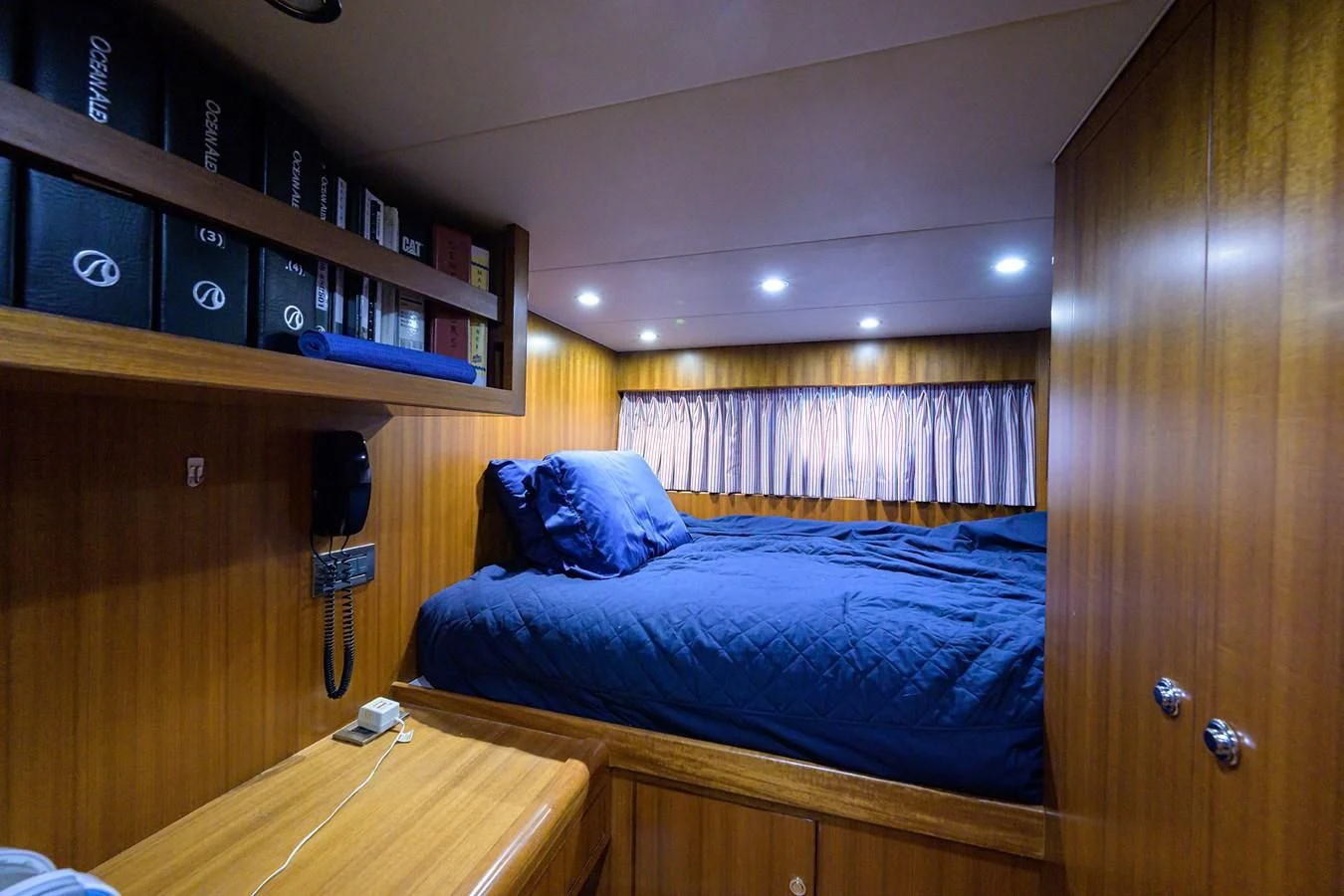 a bedroom with a bed and desk aboard BARNSTAR Yacht for Sale