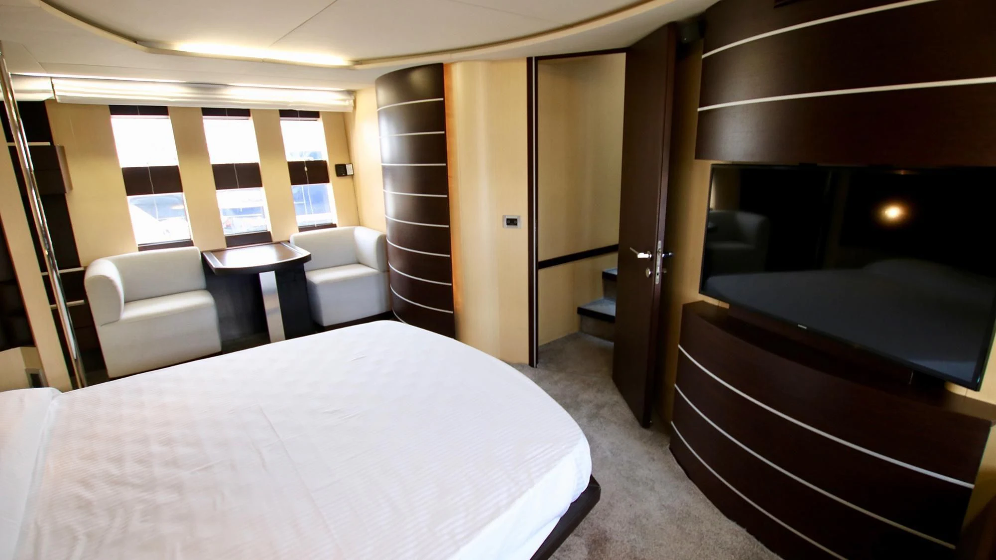 a room with a bed and a table aboard ANCHE NO! Yacht for Sale