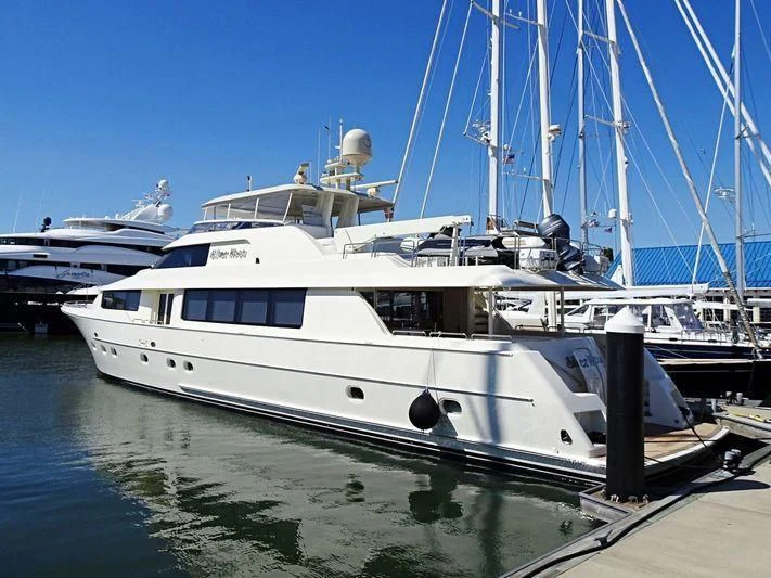 a large white boat sits at a dock aboard GRATITUDE Yacht for Sale