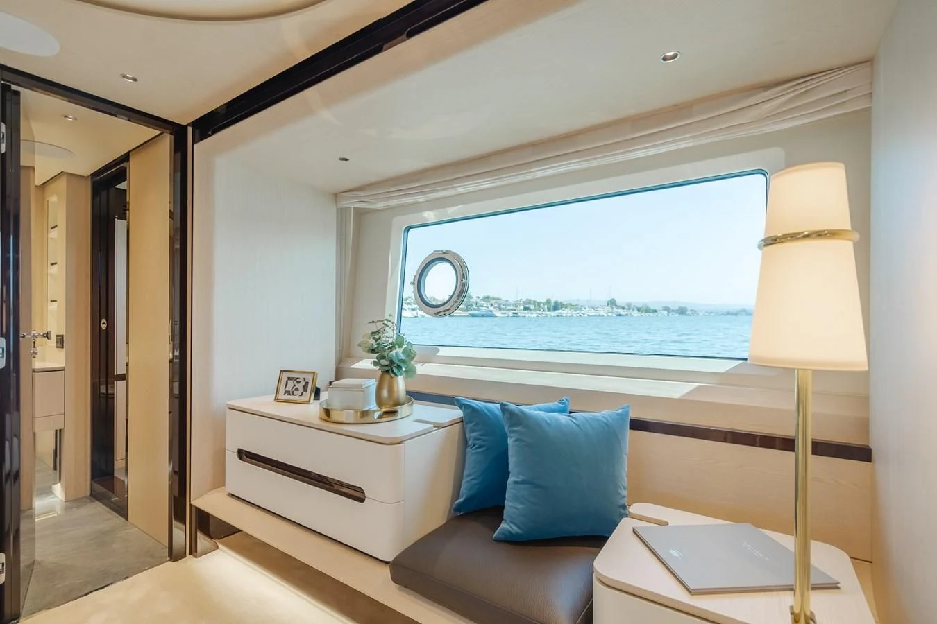 a bed with a window and a lamp in a room aboard AZIMUT 25 METRI GRANDE Yacht for Sale