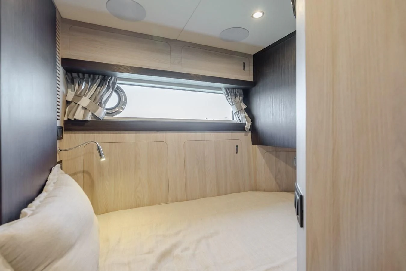a room with a bed and a window aboard AZIMUT 25 METRI GRANDE Yacht for Sale