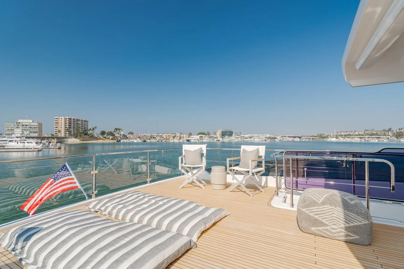 a deck with chairs and a flag on it aboard AZIMUT 25 METRI GRANDE Yacht for Sale