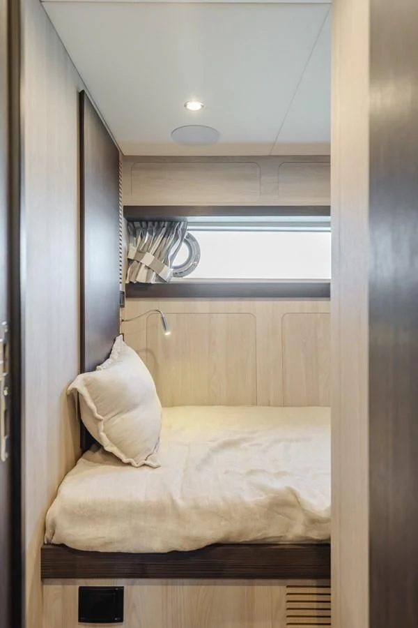 a bed with a white pillow aboard AZIMUT 25 METRI GRANDE Yacht for Sale