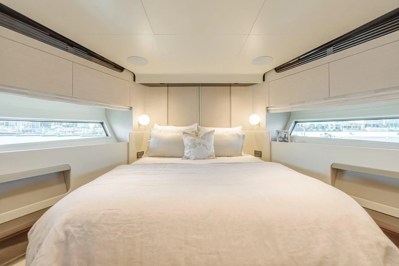 a bed with a white bed spread aboard AZIMUT 25 METRI GRANDE Yacht for Sale