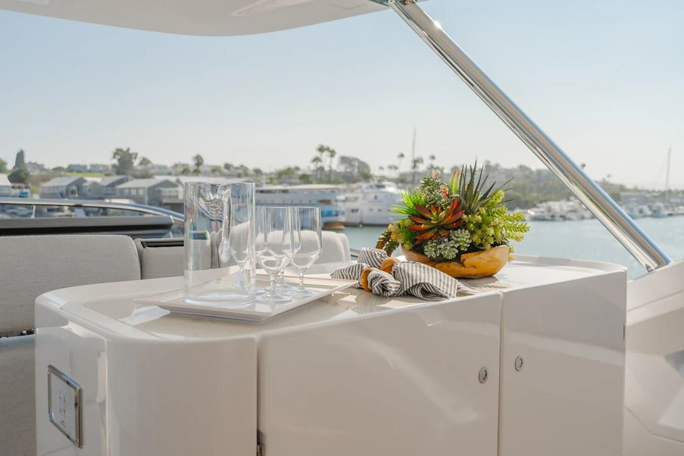 a table with wine glasses and flowers on it aboard AZIMUT 25 METRI GRANDE Yacht for Sale