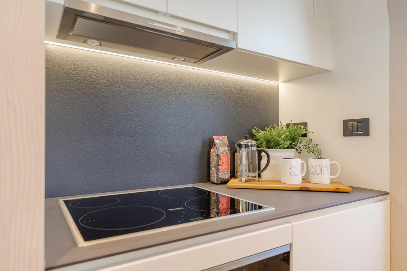 a kitchen with a stove and a shelf with a potted plant aboard AZIMUT 25 METRI GRANDE Yacht for Sale