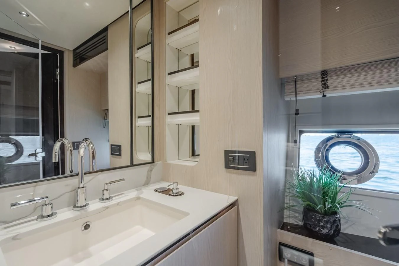 a bathroom with a sink and a plant in the window aboard AZIMUT 25 METRI GRANDE Yacht for Sale