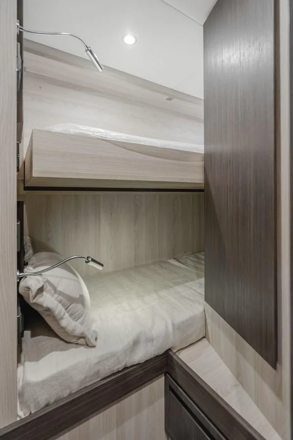 a bed with a white sheet and a white pillow aboard AZIMUT 25 METRI GRANDE Yacht for Sale