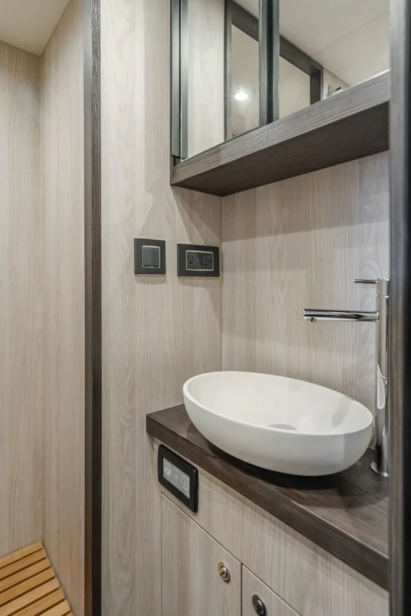 a bathroom with a sink and a mirror aboard AZIMUT 25 METRI GRANDE Yacht for Sale