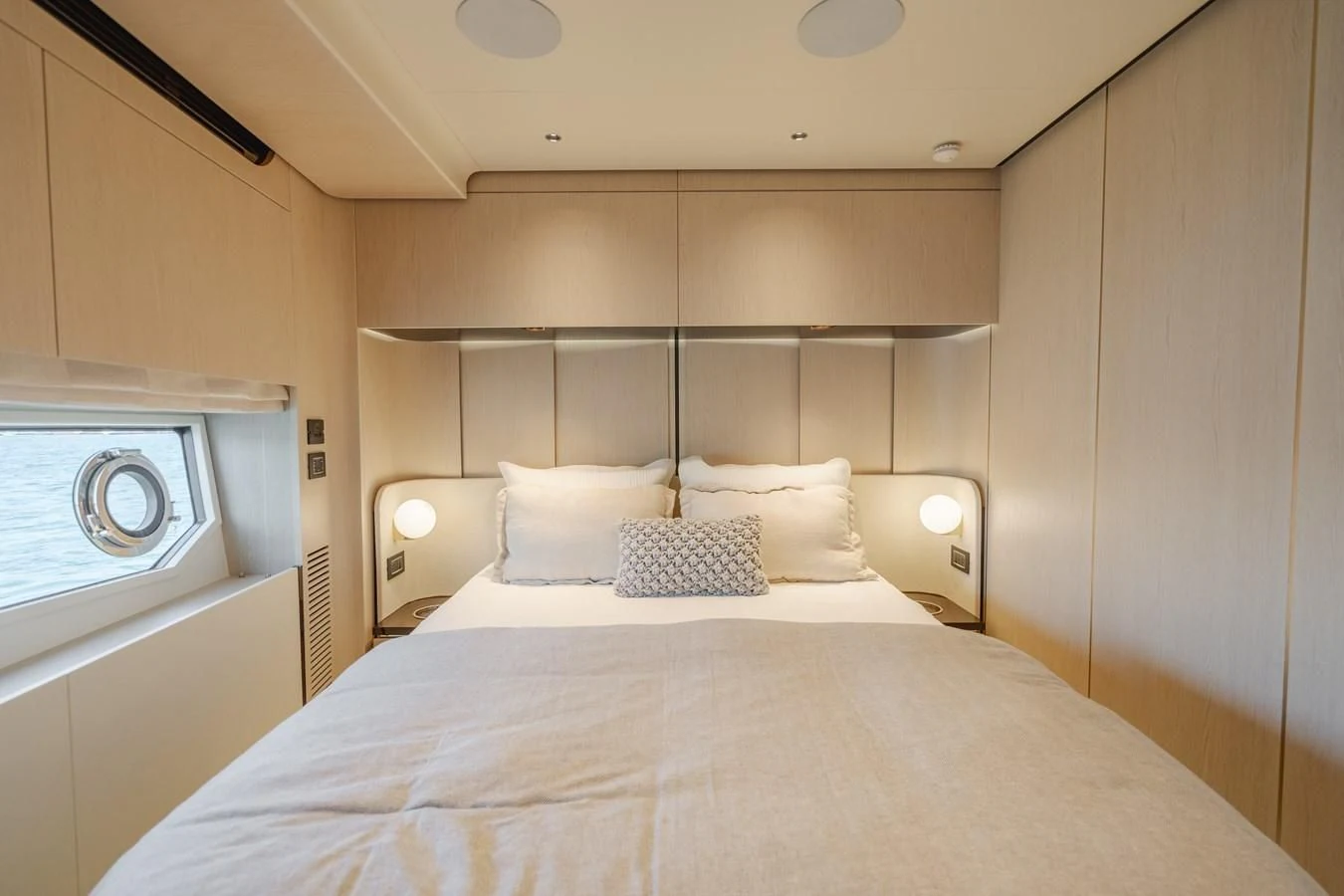 a bed with a white bed spread aboard AZIMUT 25 METRI GRANDE Yacht for Sale