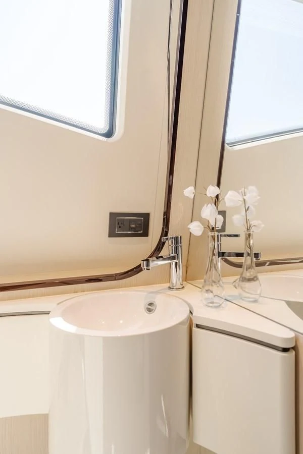 a bathroom with a sink and a mirror aboard AZIMUT 25 METRI GRANDE Yacht for Sale
