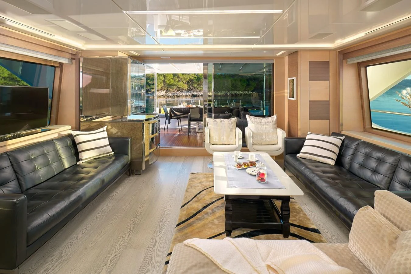 a living room with leather couches and a table aboard OCEAN DRIVE Yacht for Charter
