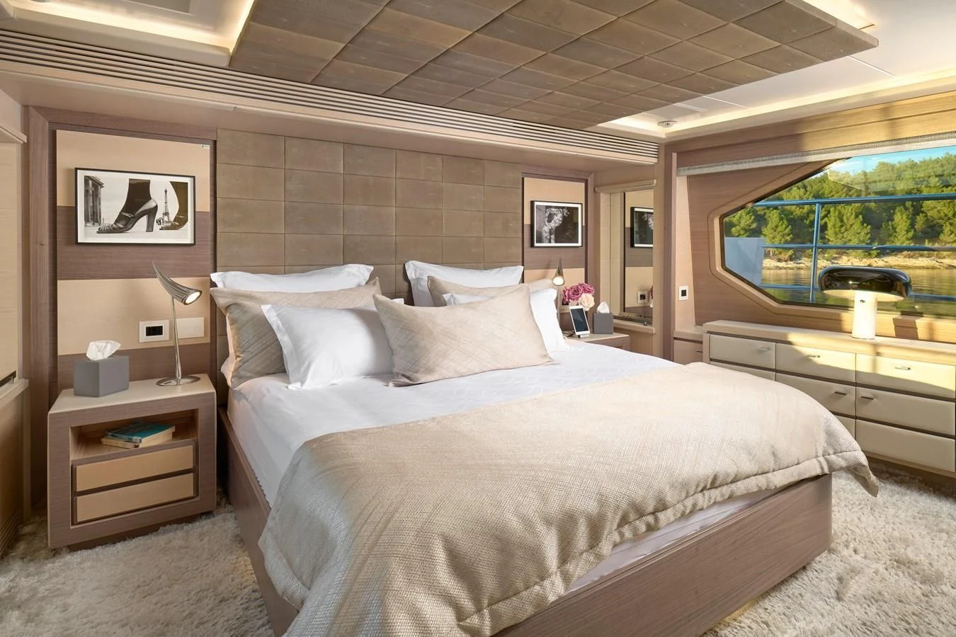 a bed with a white comforter aboard OCEAN DRIVE Yacht for Charter