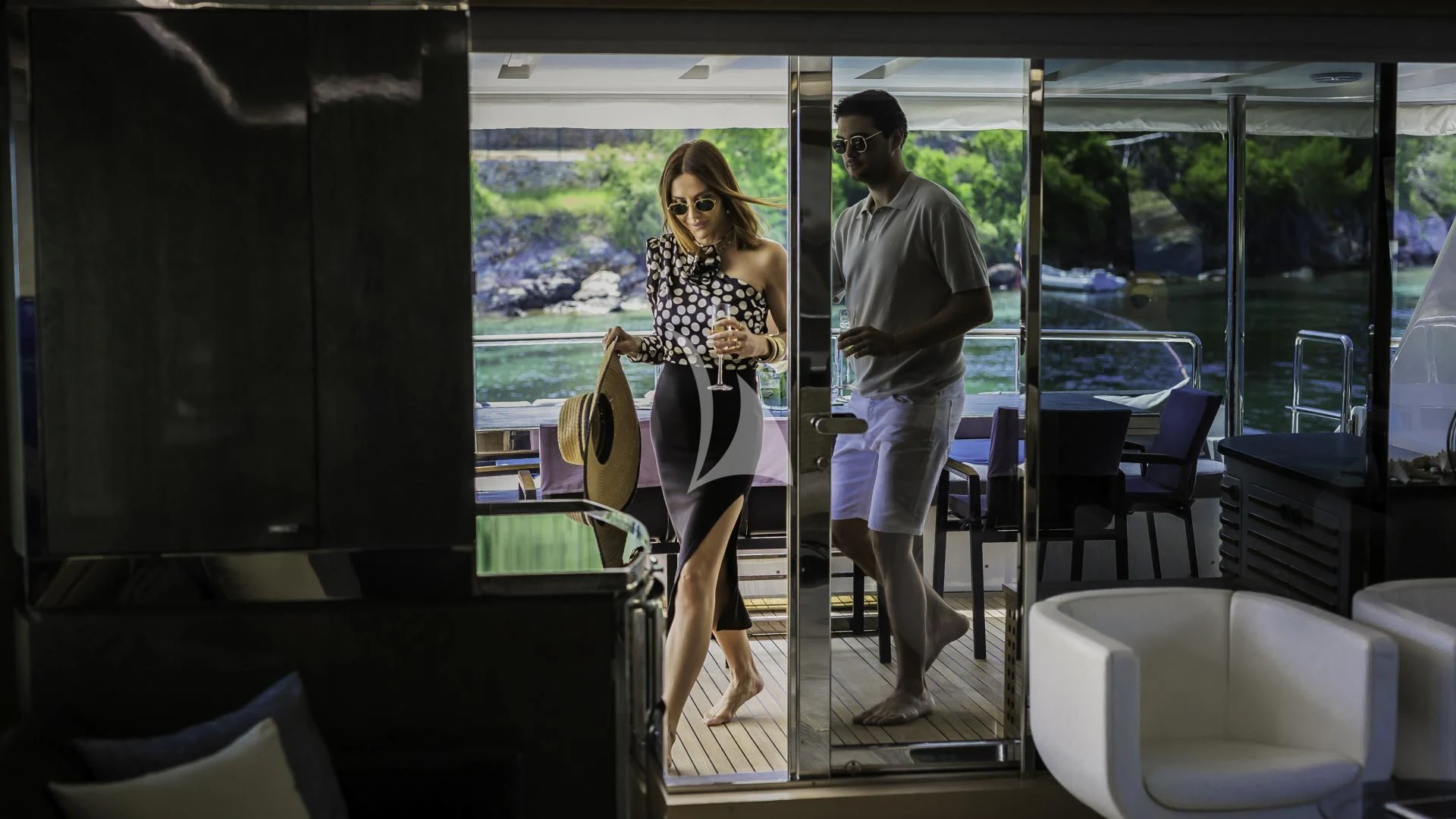 a man and woman standing on a porch with a bag and a bag aboard OCEAN DRIVE Yacht for Charter