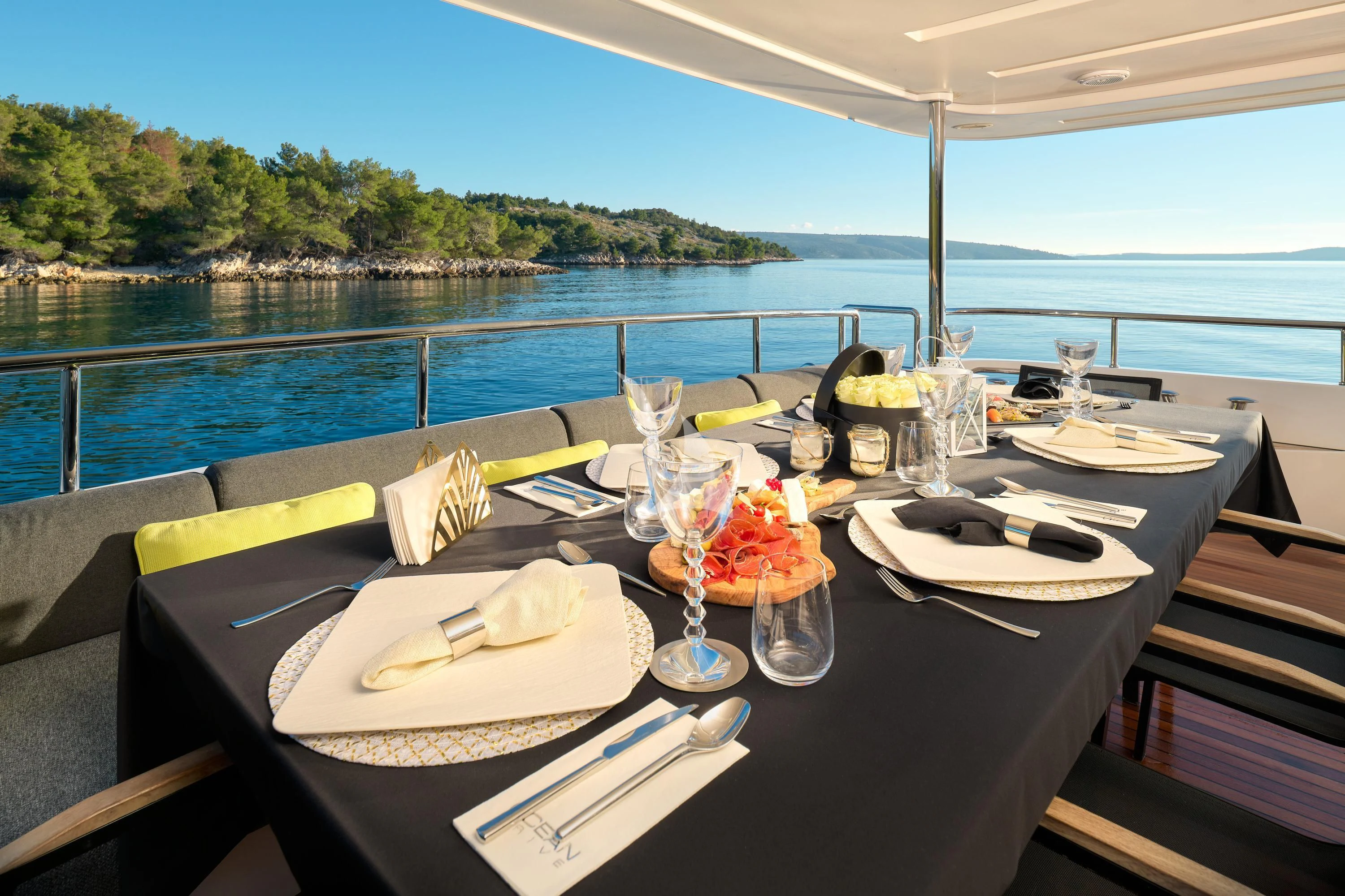 a table with plates and glasses on it aboard OCEAN DRIVE Yacht for Charter