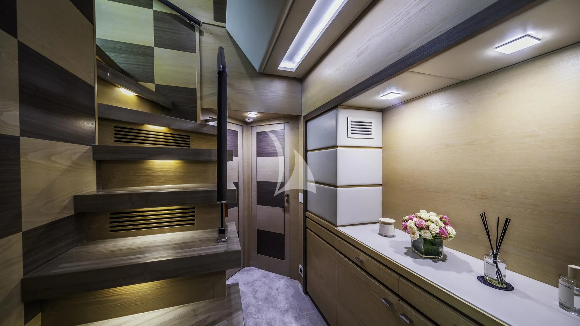 a staircase with a vase of flowers aboard OCEAN DRIVE Yacht for Charter