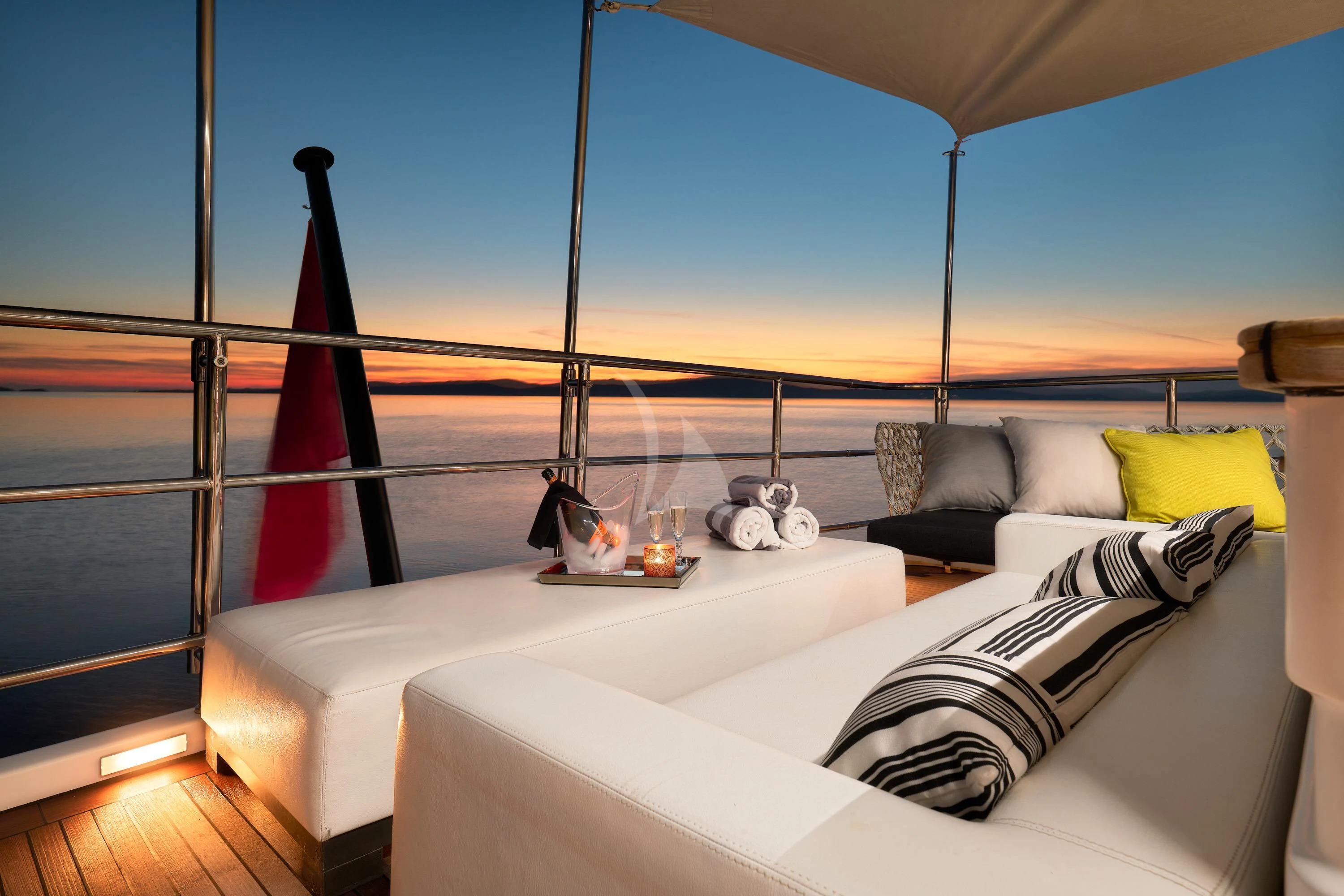 a bed with a white bed and a red lamp on the side aboard OCEAN DRIVE Yacht for Charter