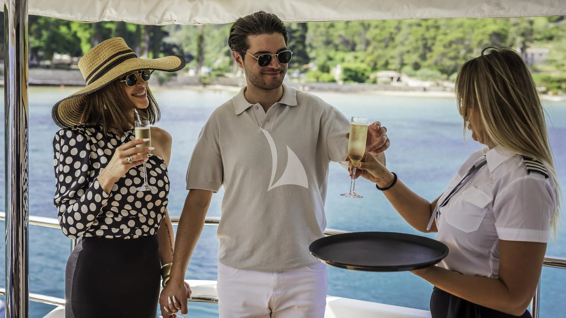 a group of people holding drinks aboard OCEAN DRIVE Yacht for Charter