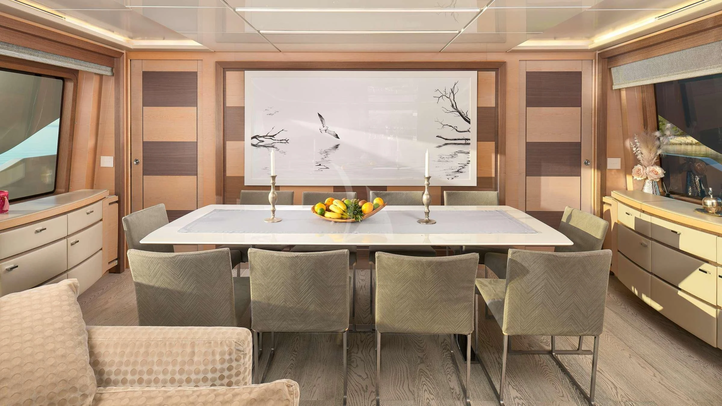 a large room with a table and chairs and a large screen aboard OCEAN DRIVE Yacht for Charter