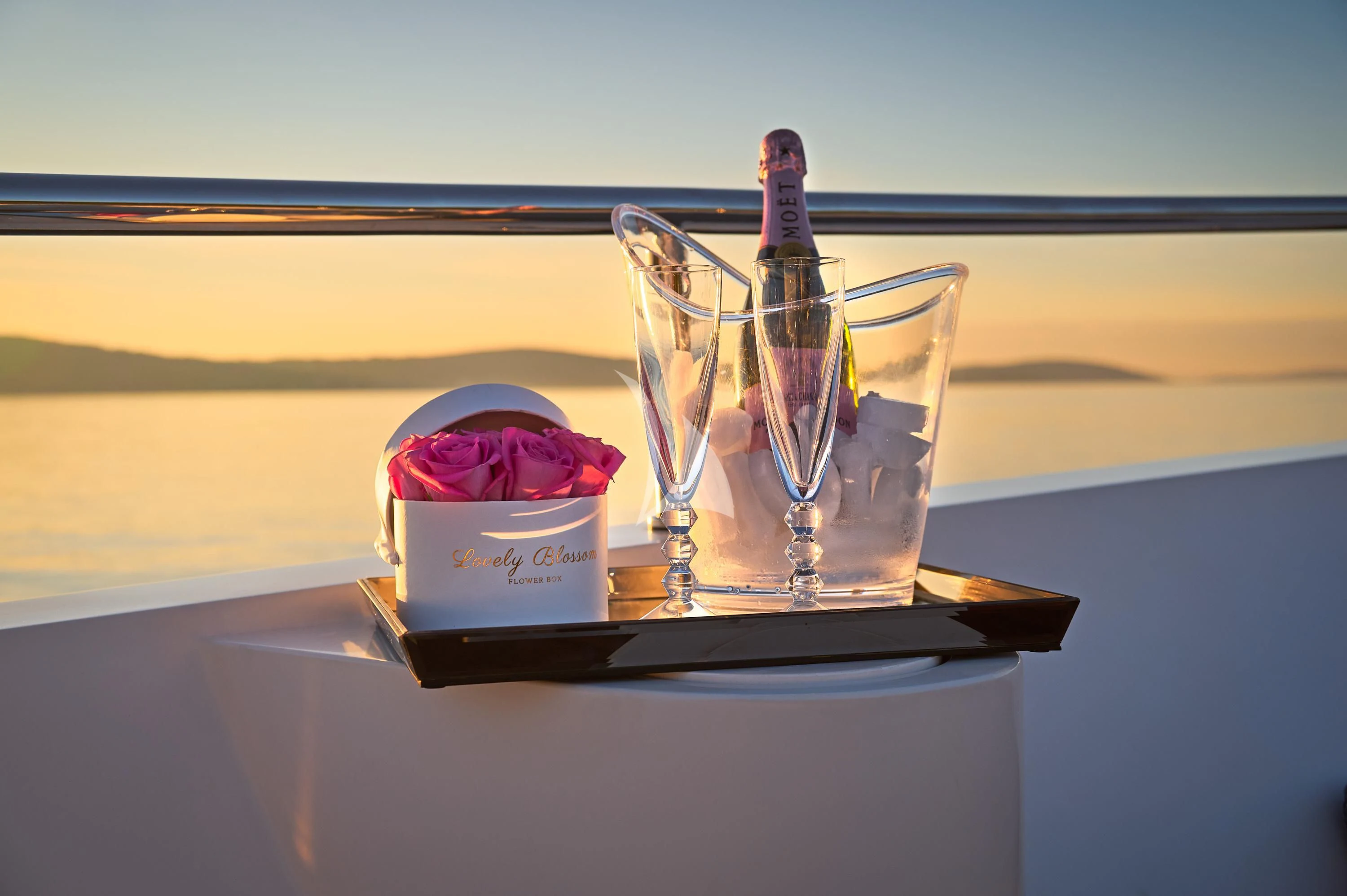 a glass bottle and a glass on a table aboard OCEAN DRIVE Yacht for Charter