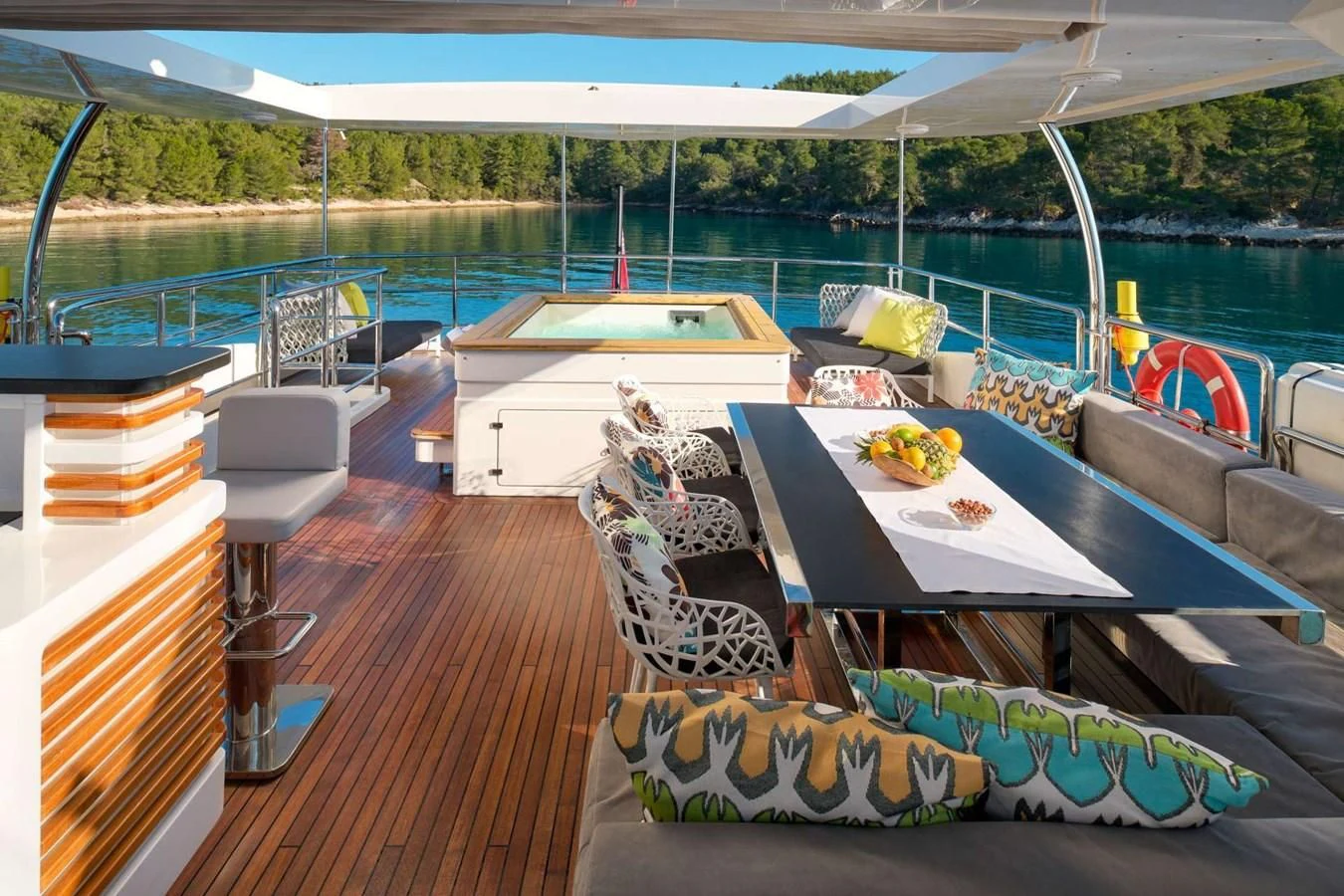 a deck with a table and chairs on it aboard OCEAN DRIVE Yacht for Charter