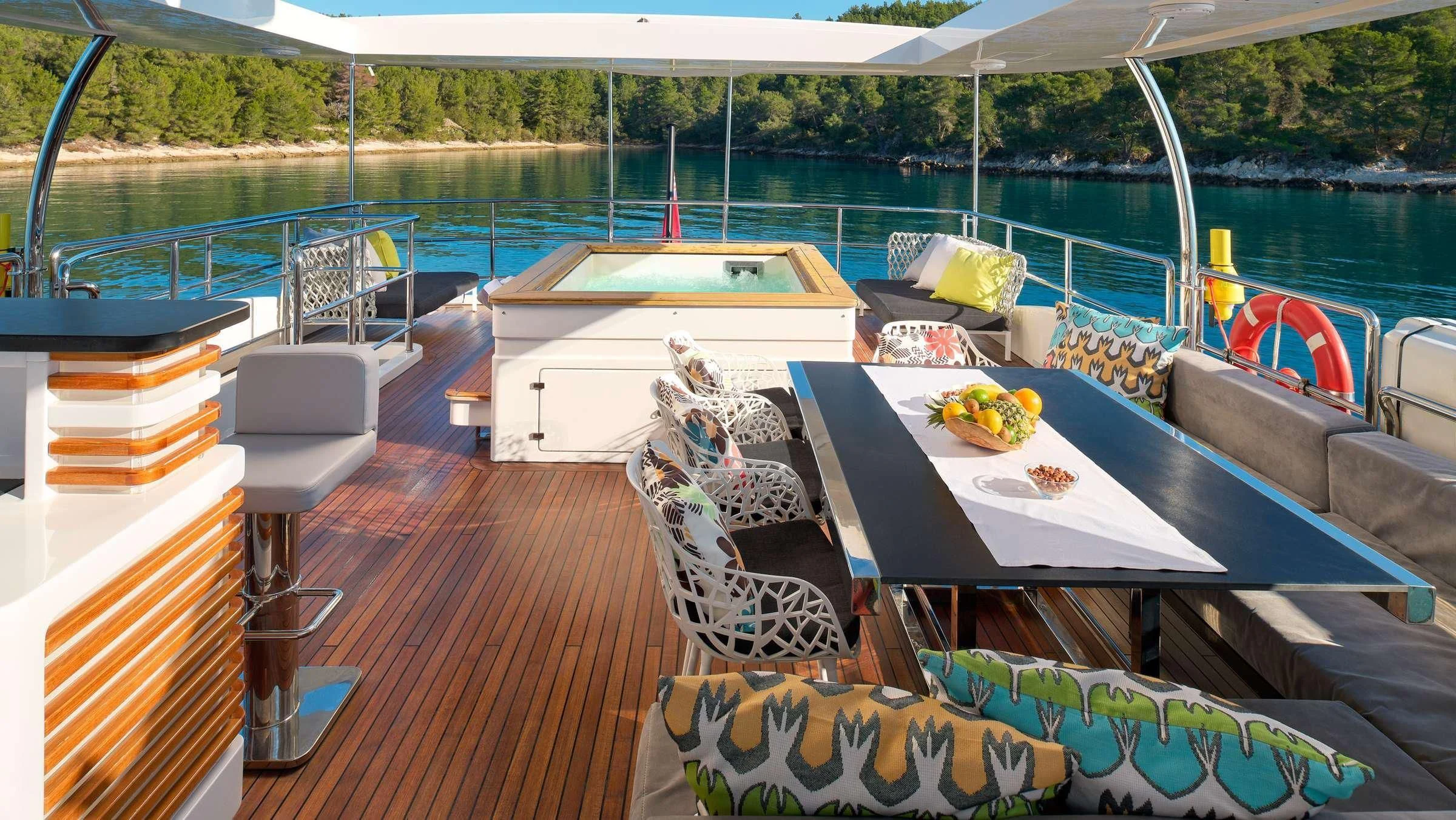 a deck with a table and chairs on it aboard OCEAN DRIVE Yacht for Charter