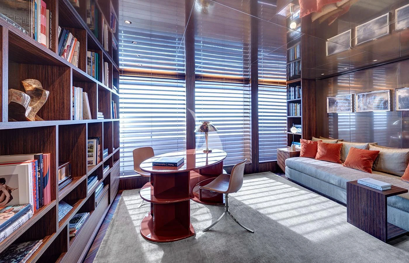a room with a couch and a table and a bookcase aboard SAVANNAH Yacht for Sale