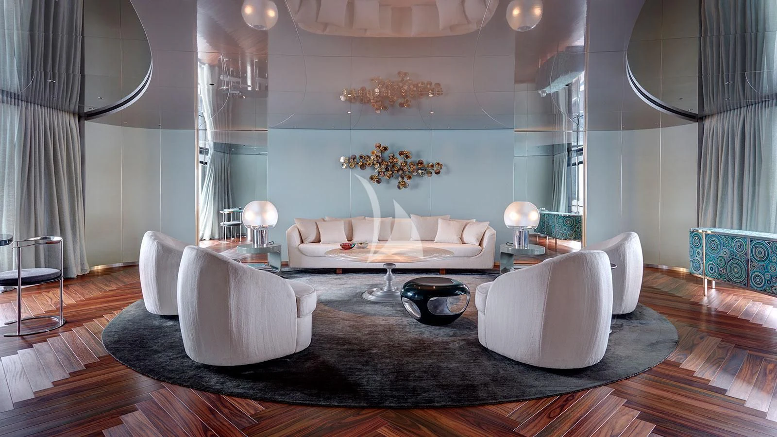 a living room with a large white couch and a large chandelier aboard SAVANNAH Yacht for Sale