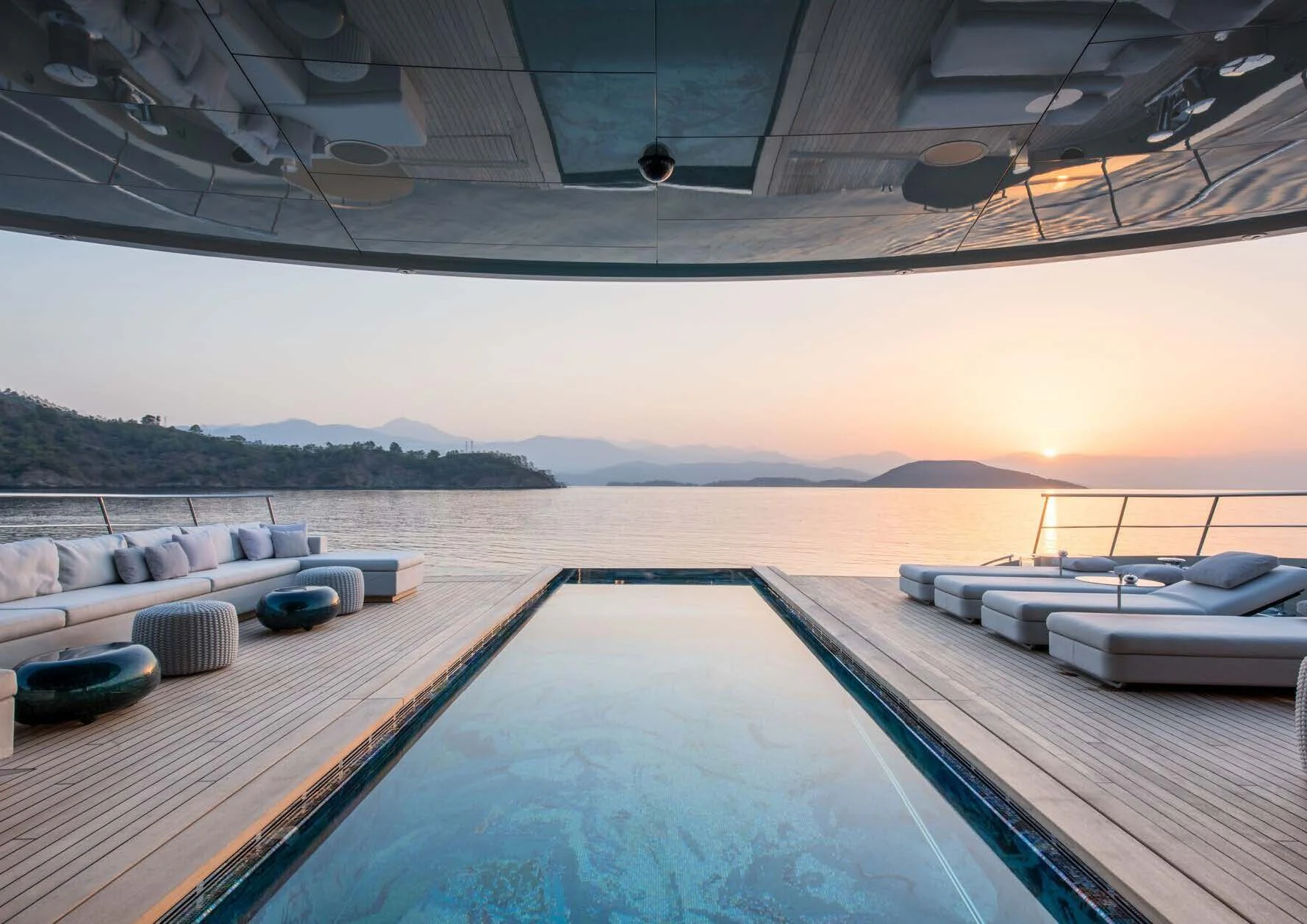 a deck with a pool and a view of the water aboard SAVANNAH Yacht for Sale