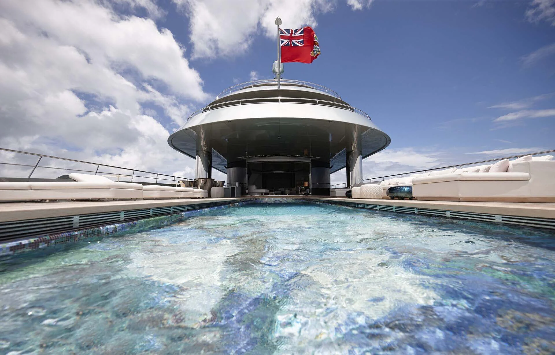 a swimming pool with a flag on it aboard SAVANNAH Yacht for Sale