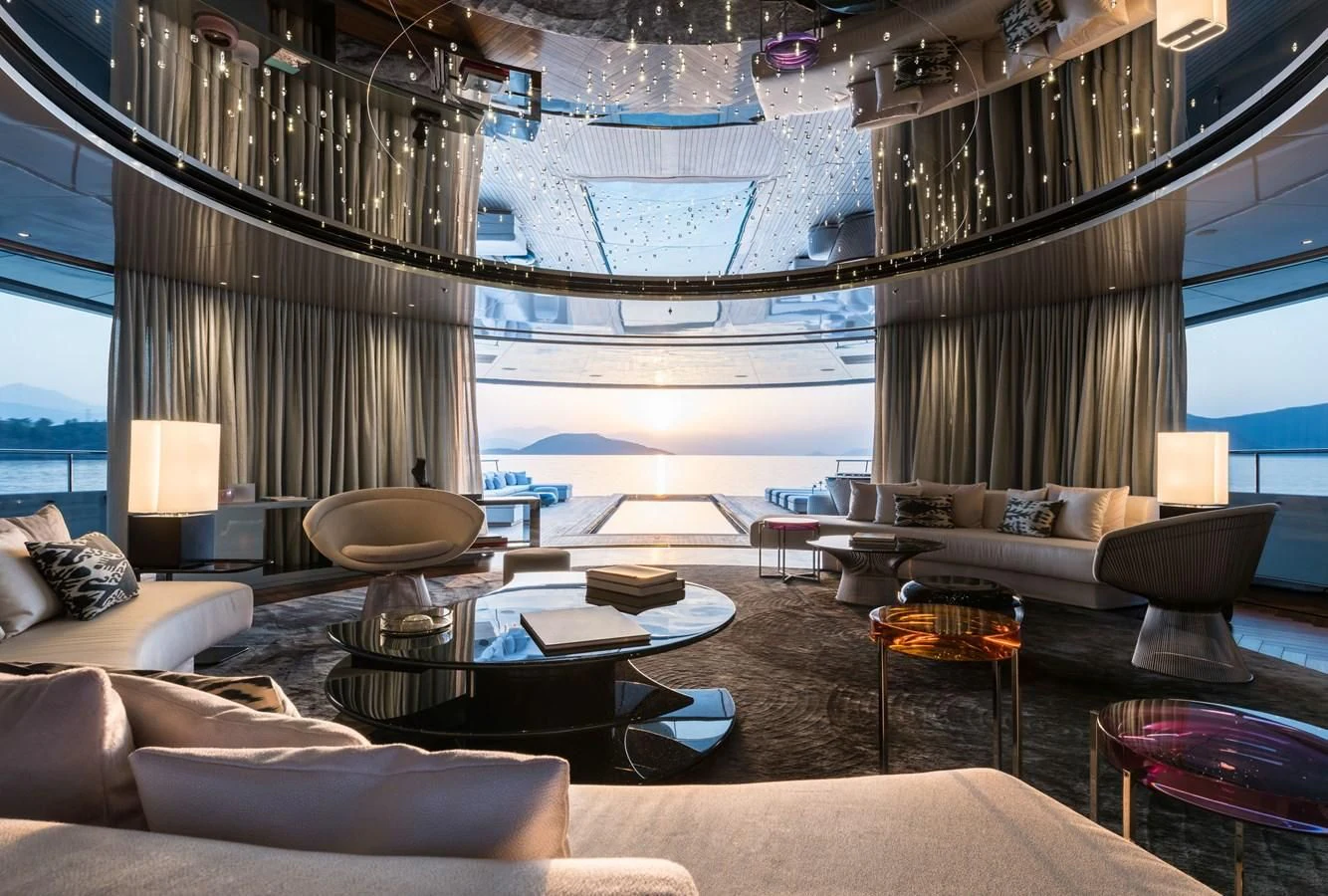 a room with a couch and a table and a large window aboard SAVANNAH Yacht for Sale