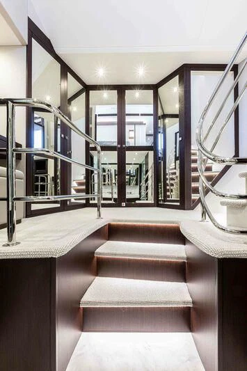a large room with a staircase aboard NEW EDGE Yacht for Sale
