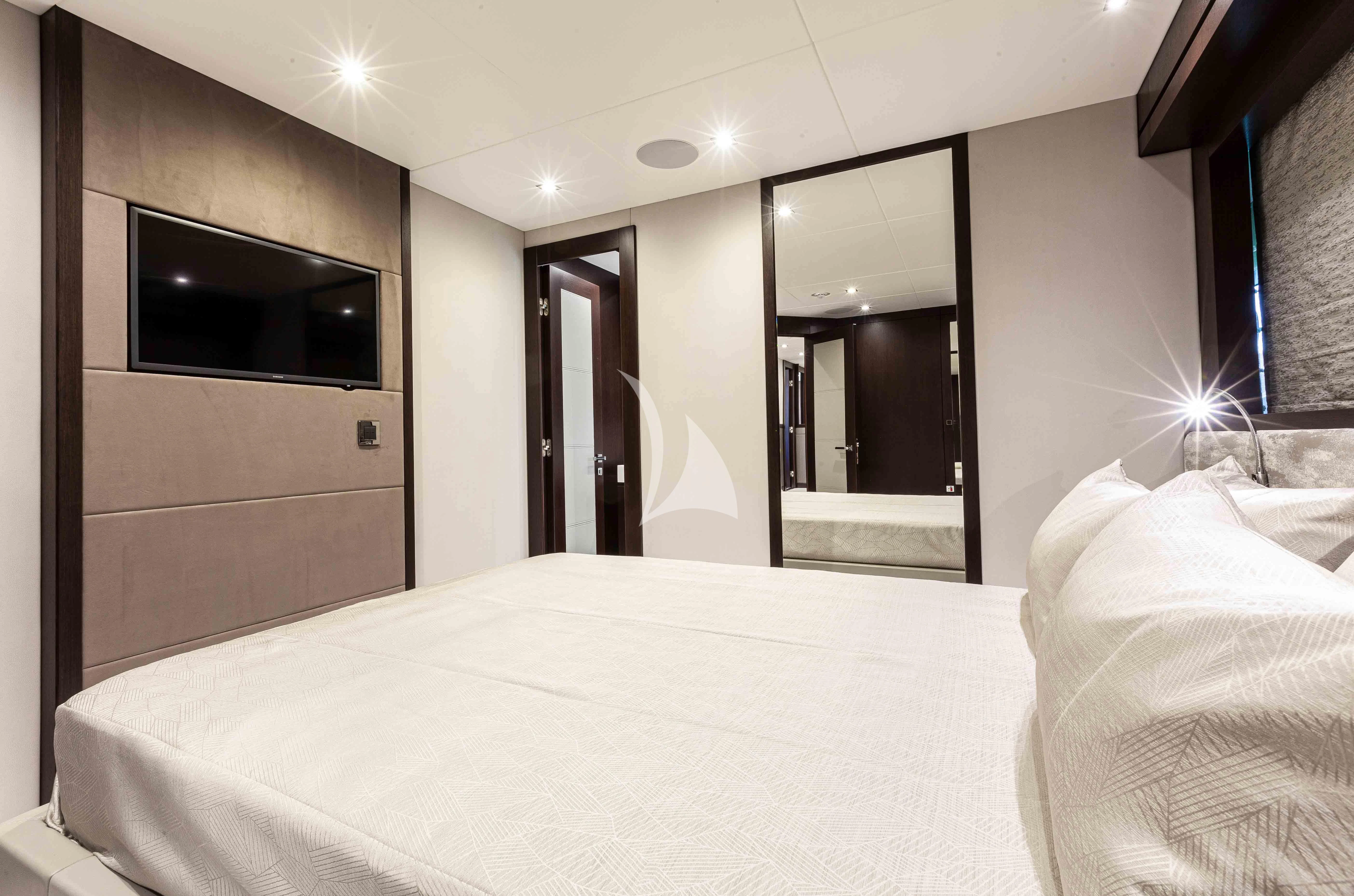 a hotel room with a bed and a tv aboard NEW EDGE Yacht for Sale