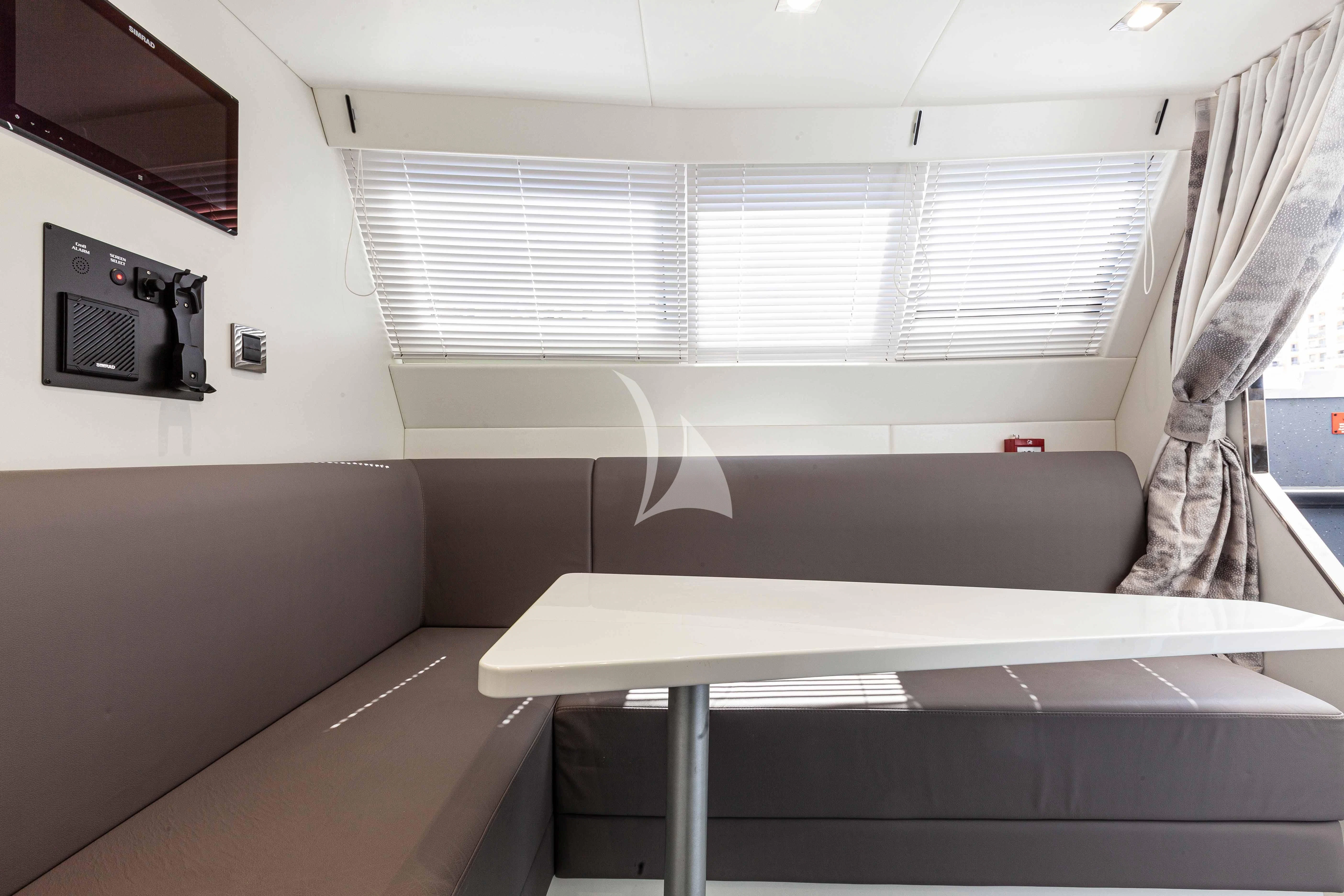 a room with a table and a tv aboard NEW EDGE Yacht for Sale