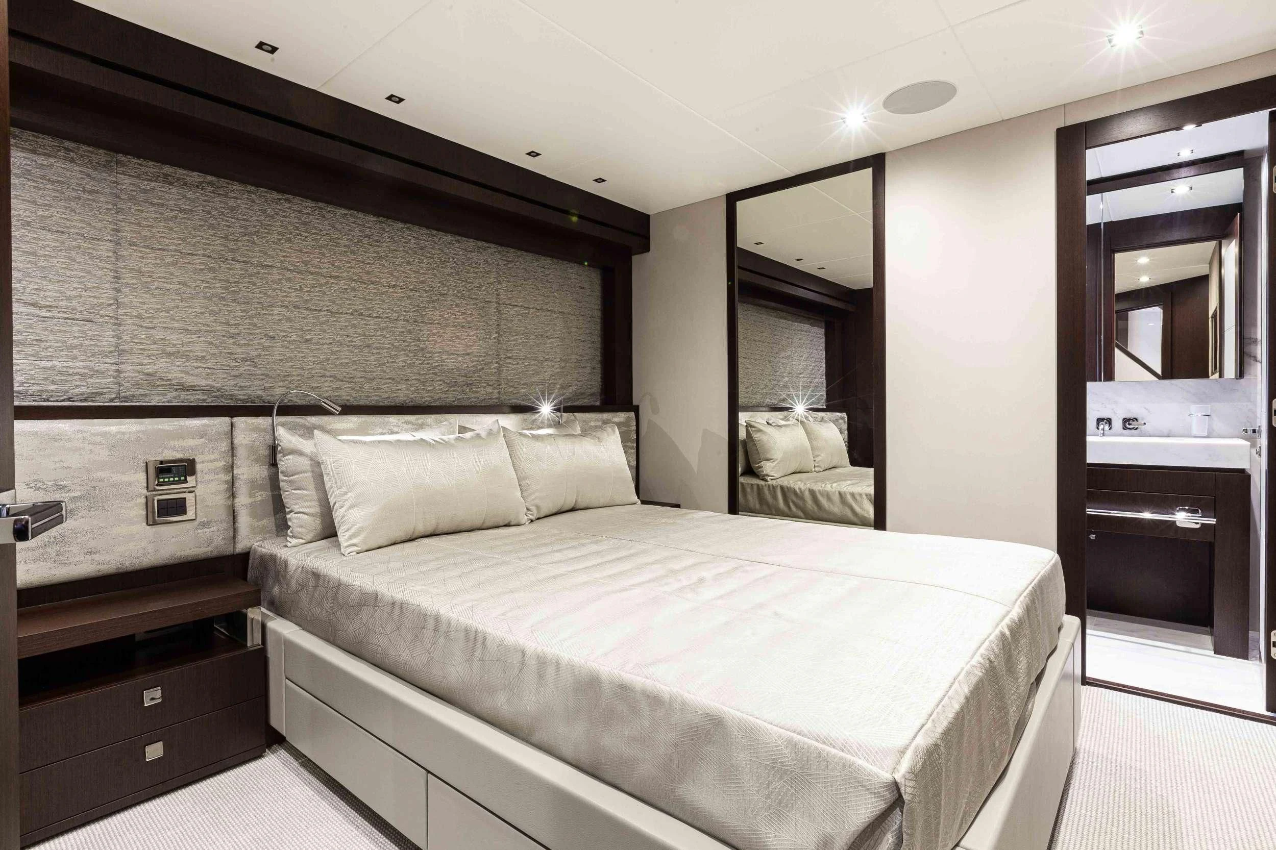 a bedroom with a bed and a mirror aboard NEW EDGE Yacht for Sale