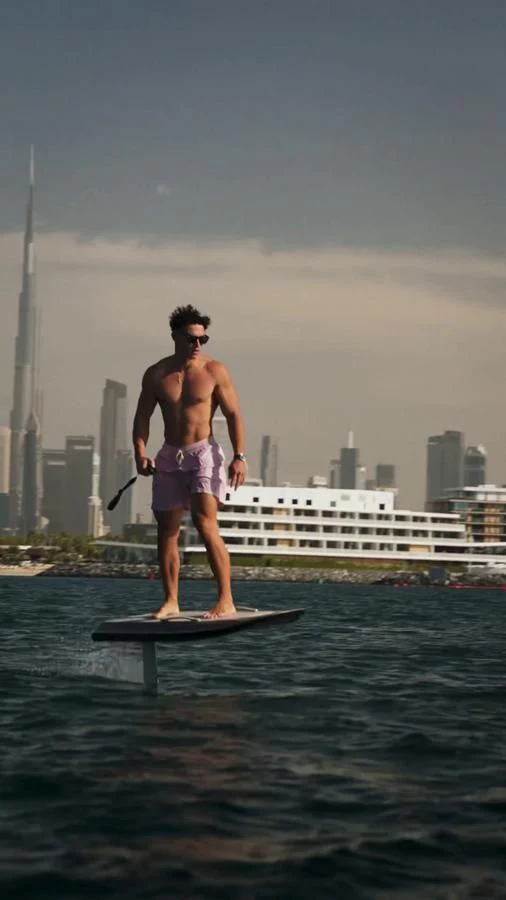 a man on a paddle board aboard NEW EDGE Yacht for Sale